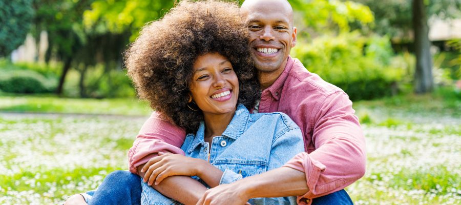 Black cheerful happy couple in love dating at the park in the nature